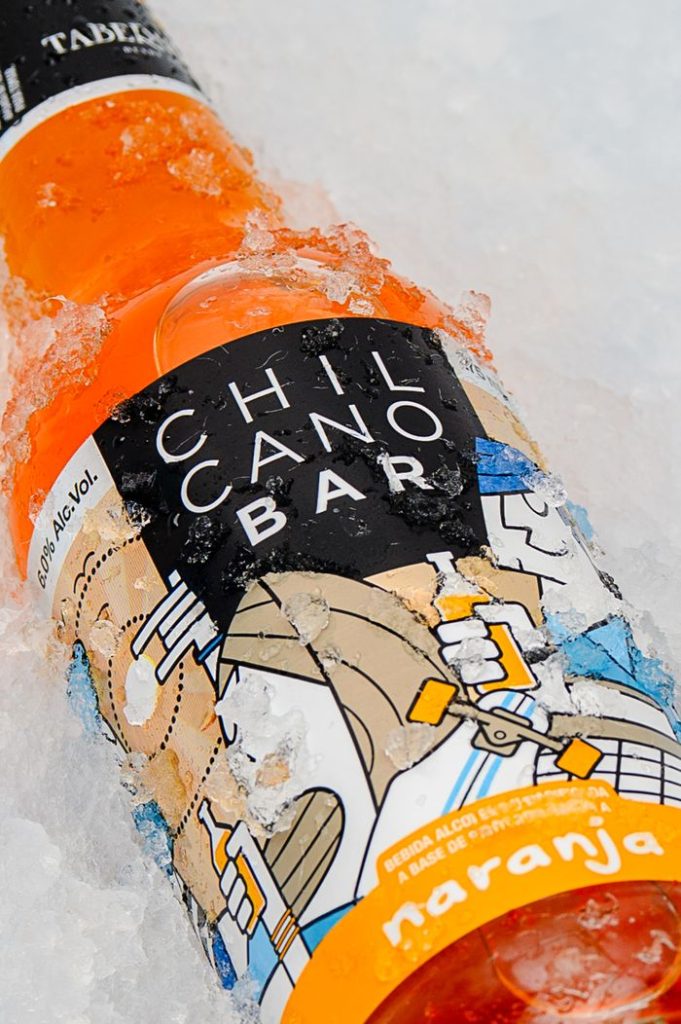 Chilcano Bar orange cocktail bottle chilled in ice, showcasing vibrant Peruvian drink culture.